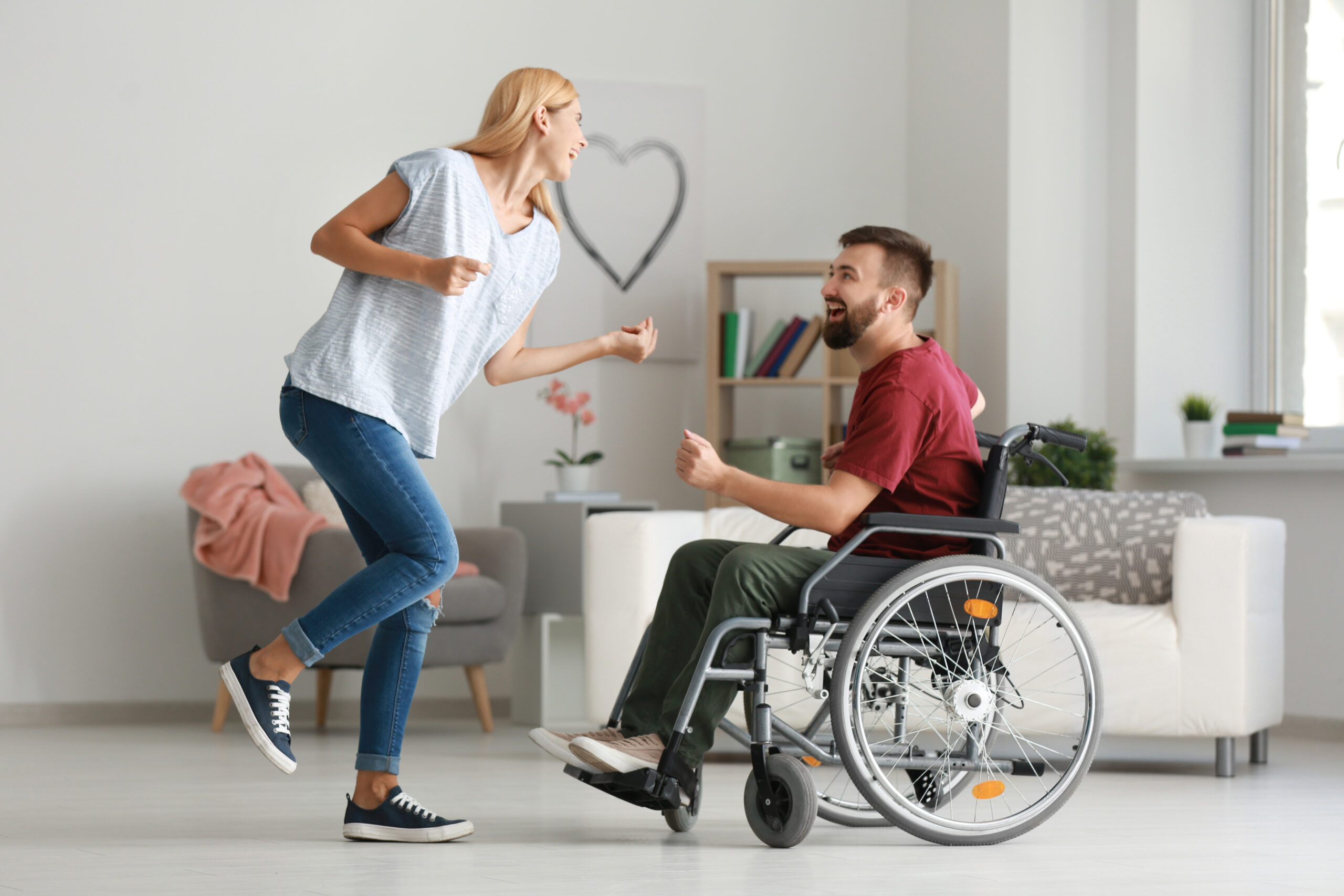 Man,In,Wheelchair,With,Beautiful,Woman,Dancing,At,Home